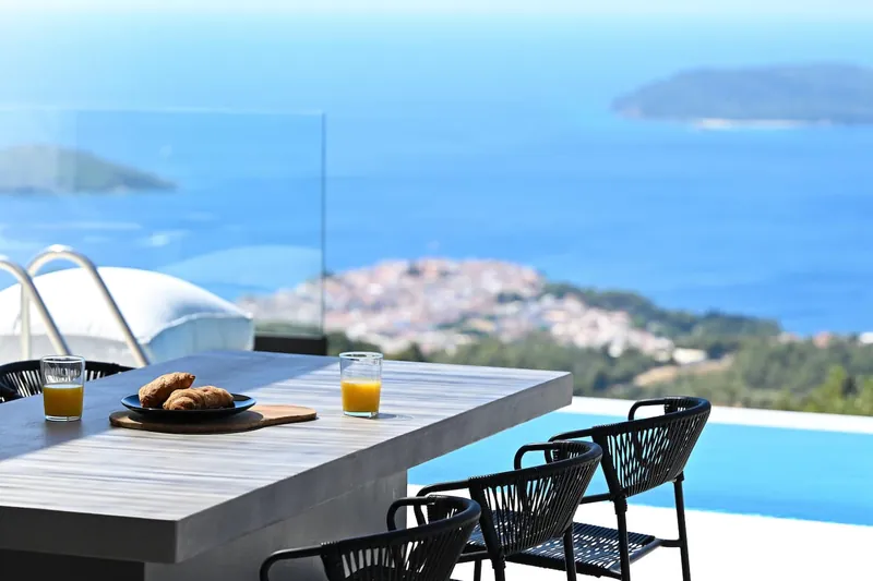 Breakfast on the terrace bar above the pool, with Skiathos Town and the sea below