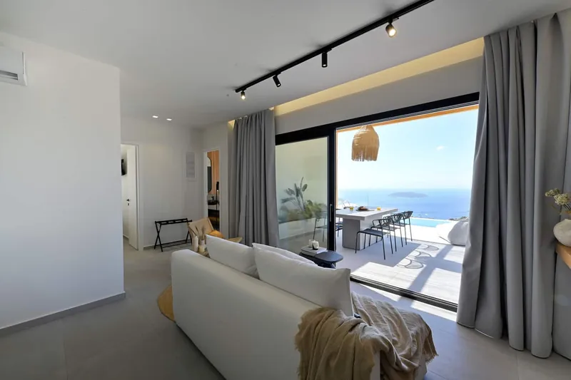 The living room with its sofa and glass doors to the terrace
