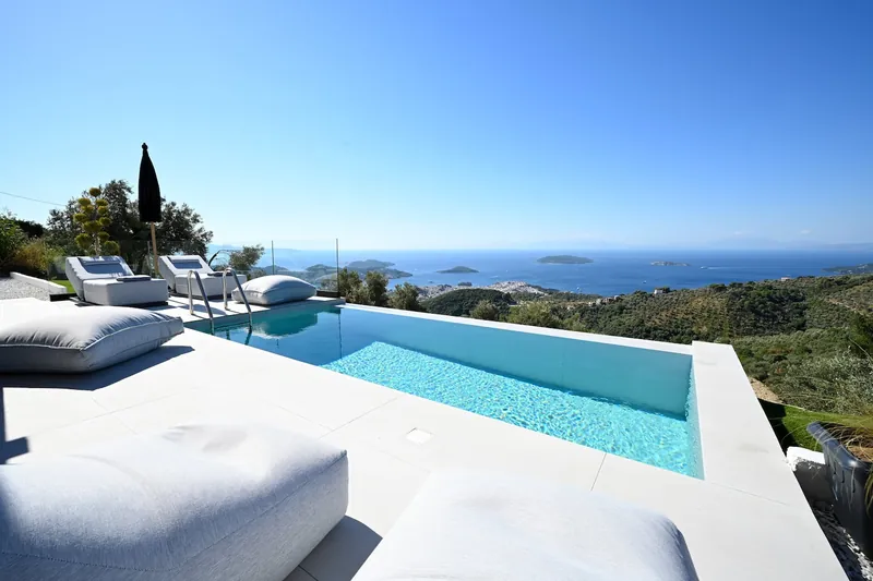 The pool, the day beds and the sea view on a clear day