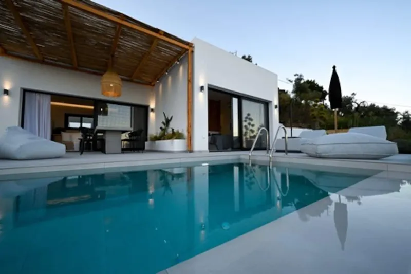 The pool in front of the villa and its reed-covered pergola