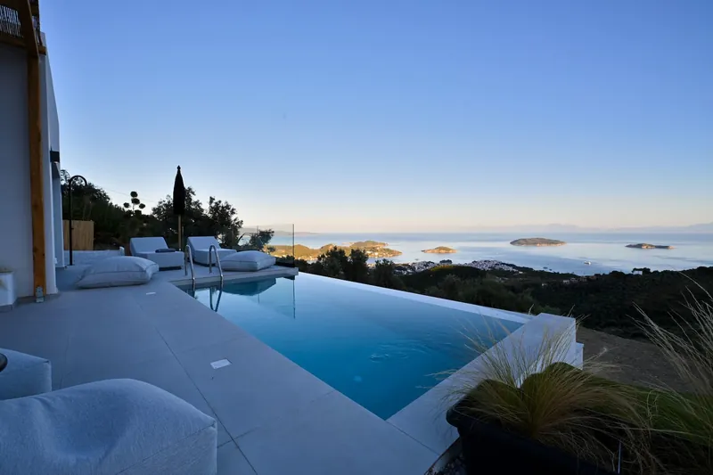 The pool and the terrace at dusk, the islets on a calm sea