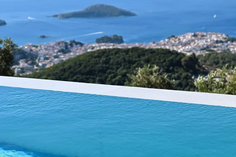 The pool’s edge with Skiathos Town and an islet beyond