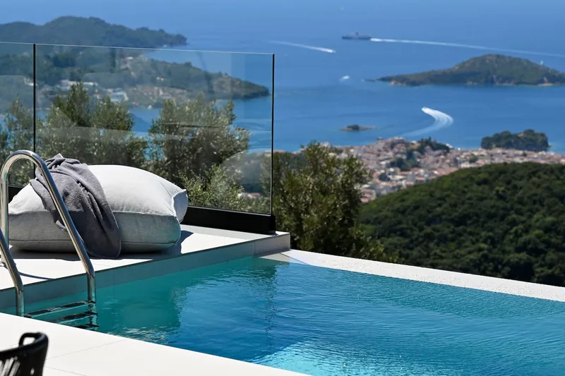 A day bed by the pool, looking down on Skiathos Town, the harbour and the islets