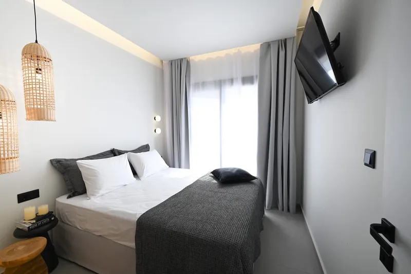 The second bedroom, with rattan lamps and a double bed