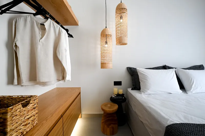 The second bedroom’s open wardrobe and rattan lamps