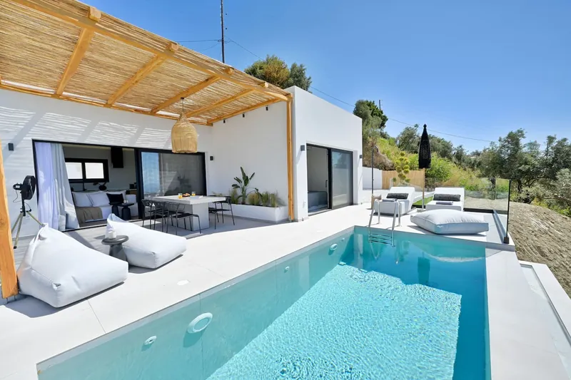 The white villa, the terrace and the pool from the garden side